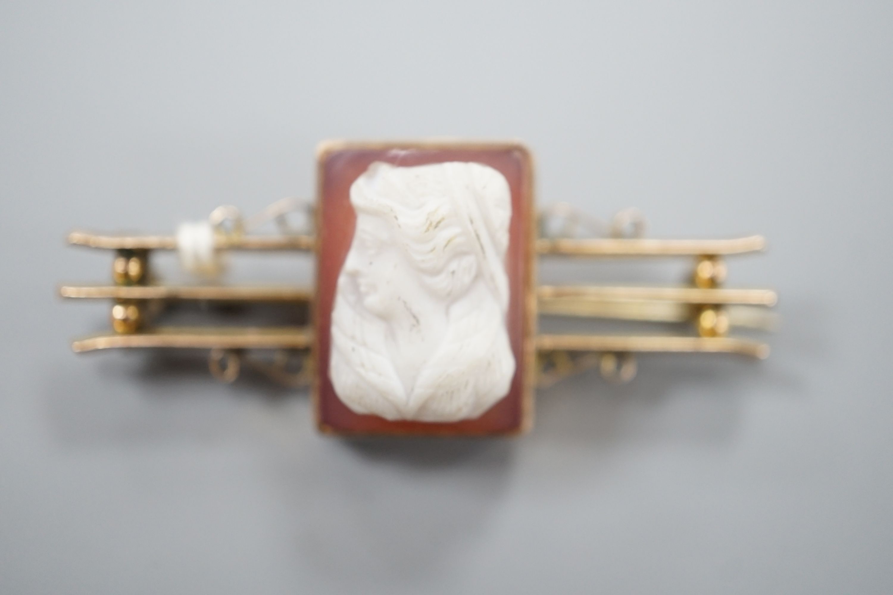 An early 20th century 9cy and sardonyx square cameo set bar brooch, carved with the bust of a lady to dexter, 45mm, gross weight 7.6 grams.